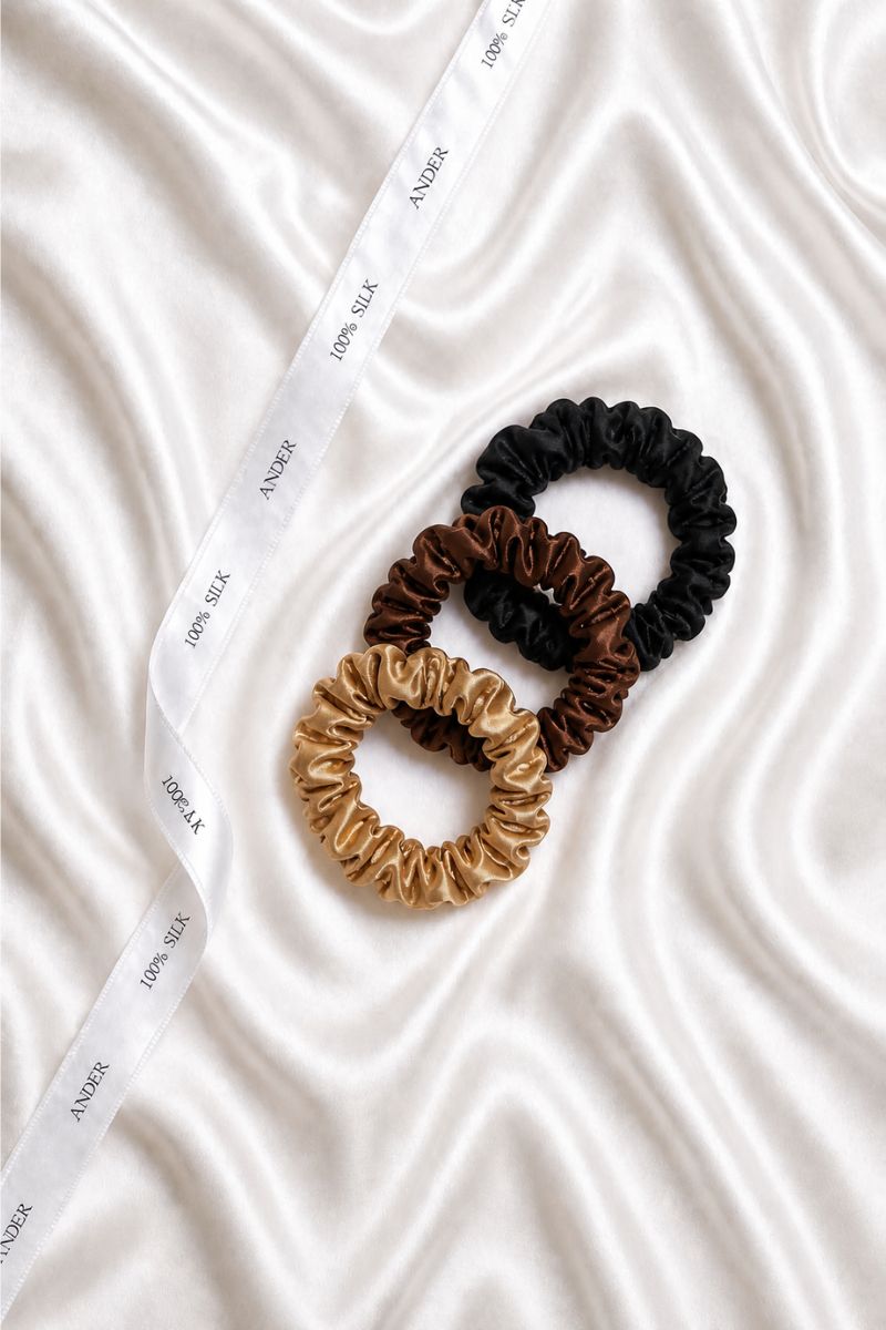 Komplet trzech jedwabnych gumek do włosów w neutralnych kolorach.
Zestaw mini scrunchie SILQ z jedwabiu naturalnego.